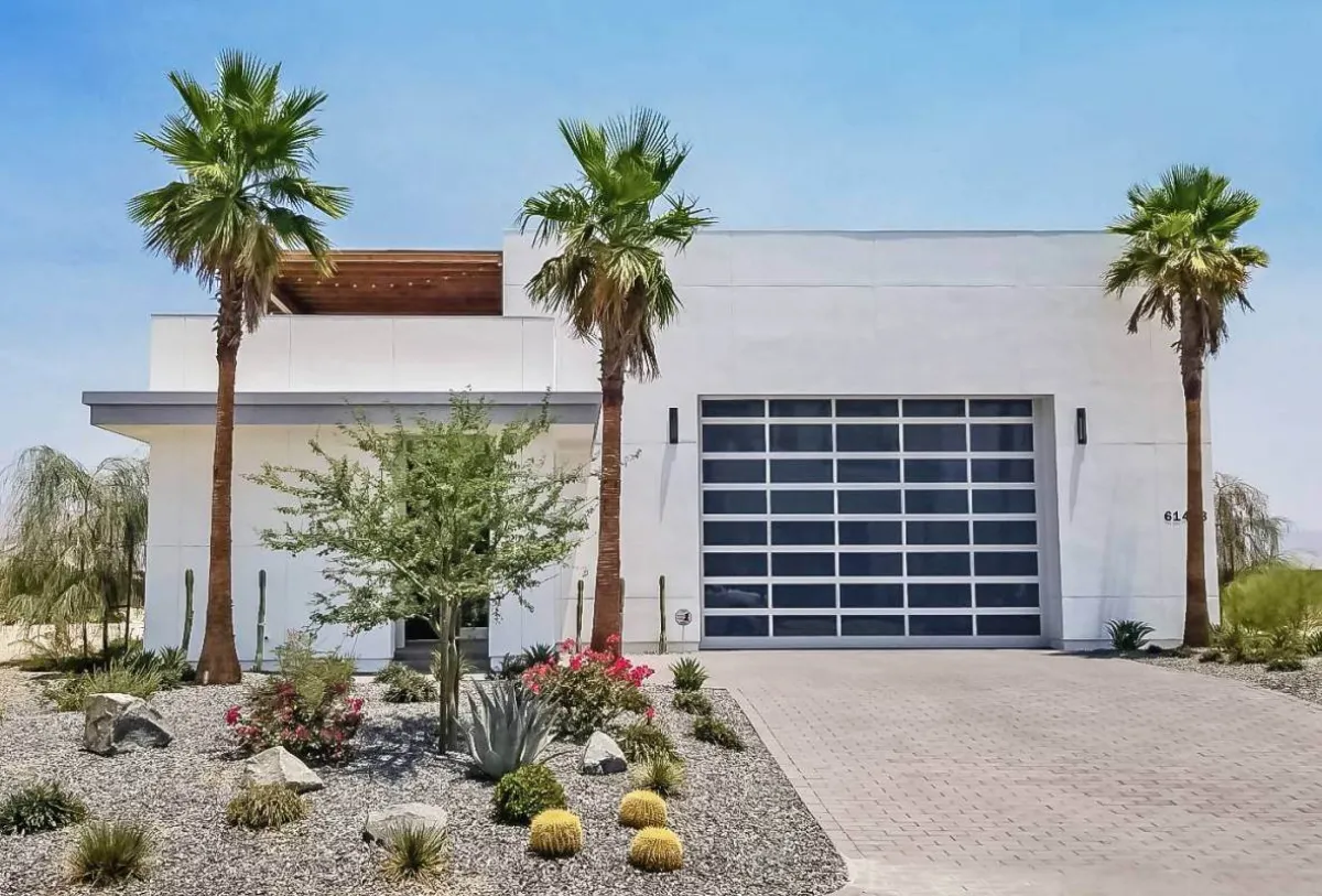 Full-view aluminum and glass garage door on a modern home