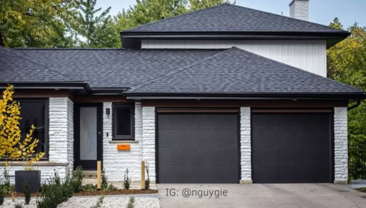 New dark grey recessed panel garage door — a replacement that transforms the home